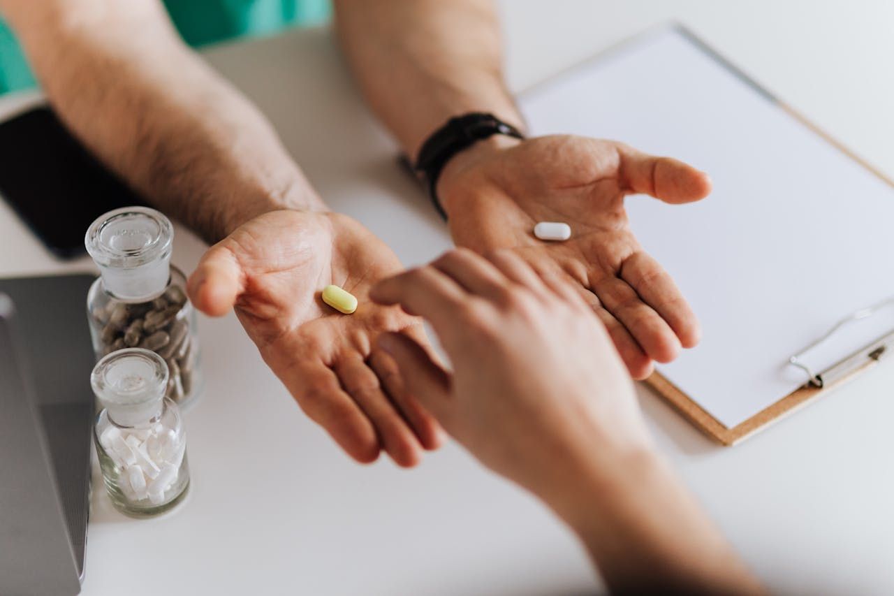 Healthcare practitioner offering choice between two supplements in his office