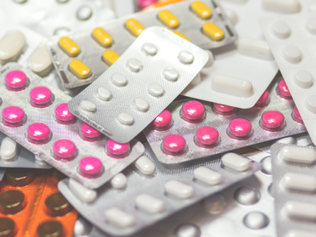 Assorted blister packs of various pills in different colors and shapes, representing a variety of non-NSAID pain relief medications.