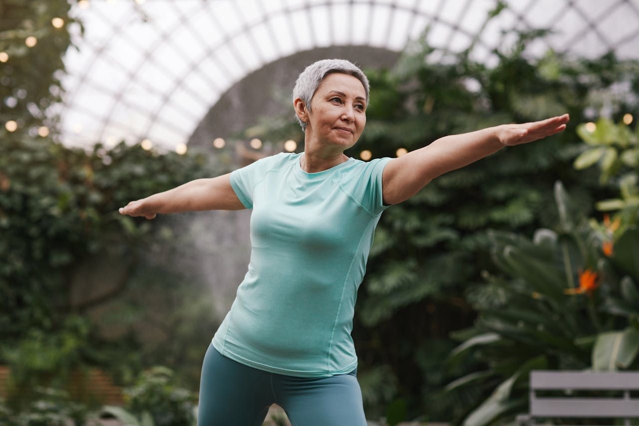 An older woman doing a warrior pose