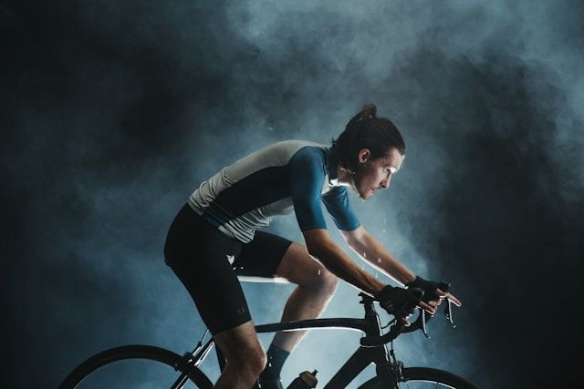 Endurance cyclist dripping sweat against a smoky background