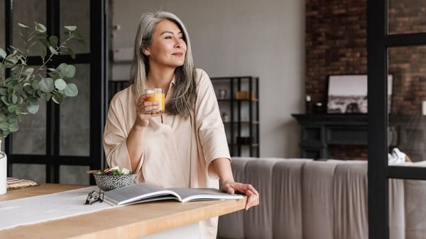 An image of a woman taking supplement