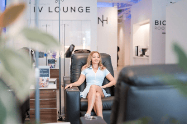 A woman sits in an IV lounge wellness clinic