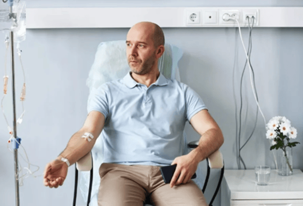 A man receiving IV treatment in a clinic