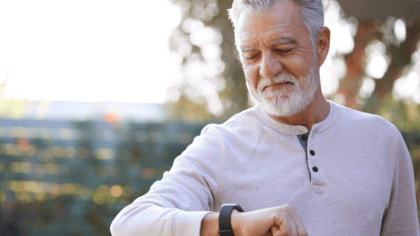What's the Difference Between NMN vs NAD? 4 An older man looking at his watch on a jog outdoors