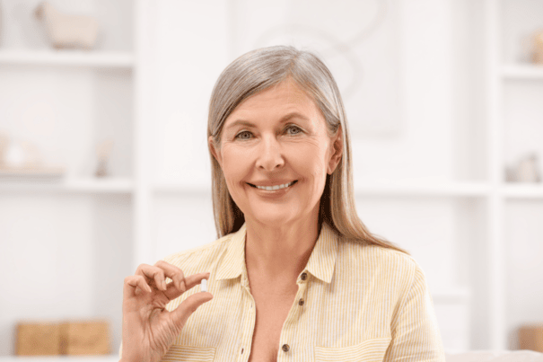 An image of a glowing matured woman taking supplement