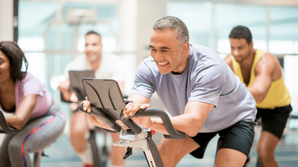 An image of men and women at the gym