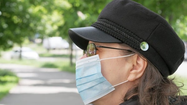 A woman in a face mask outdoors