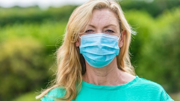 An image of woman in a face mask outdoors