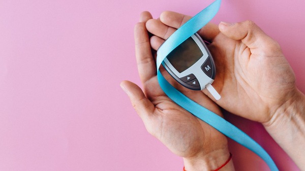 Hands holding a blood sugar monitor