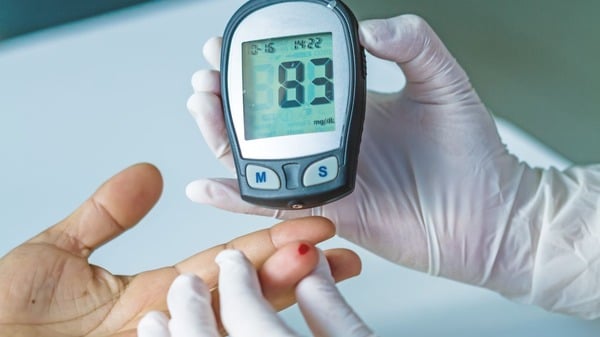 A woman receiving a blood sugar test