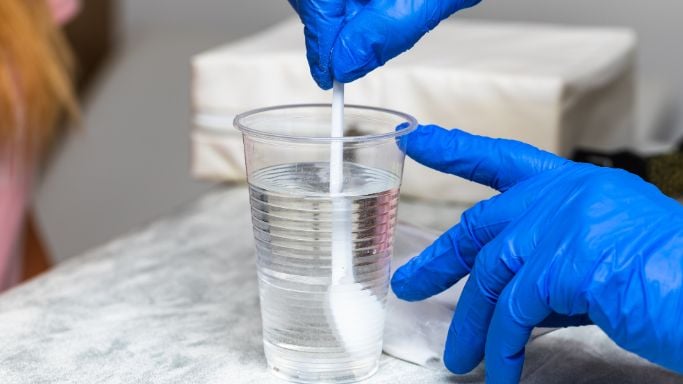 An doctor stirring a solution