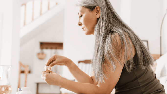 Creatine and Caffeine: A Science-Based Guide 4 An image of a matured woman taking supplements