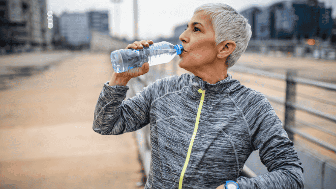 An image of a woman drinking from a water bottle