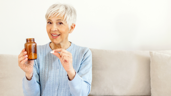 An image of a woman taking supplement