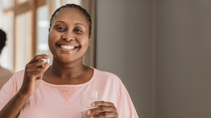 An image of a woman taking supplements
