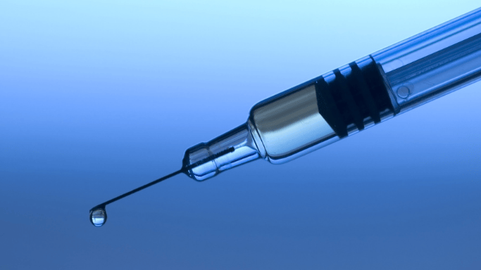 A close-up image of a medical syringe, filled and ready for use.
