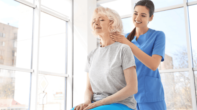 An image of a woman receiving physical therapy by a nurse
