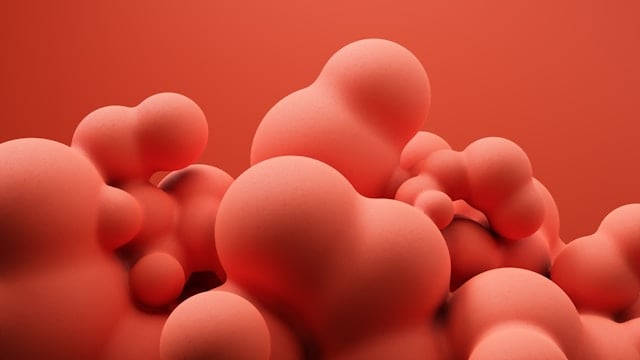 A collection of smooth, rounded red 3D shapes clustered together on a matching background.
