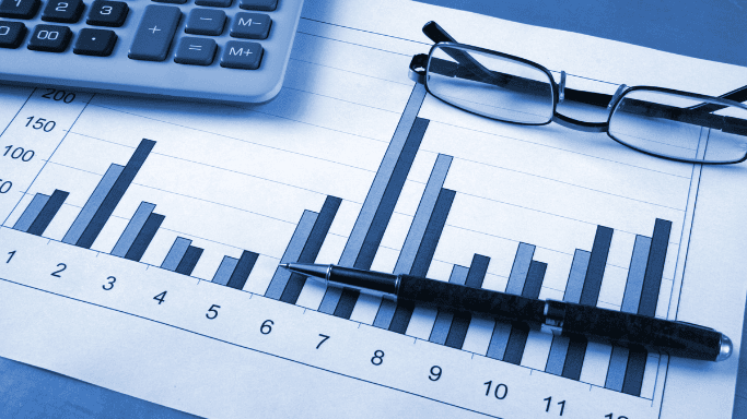 Is Niacin Good for Your Heart? New Studies Show Hidden Risks 4 An image showing bar chart with pen, eyeglasses, and calculator on a desk, shown in blue tone.