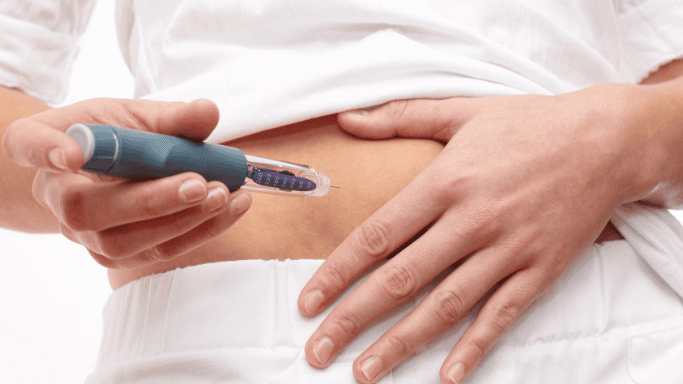 Close-up of a woman’s abdomen during an insulin test.