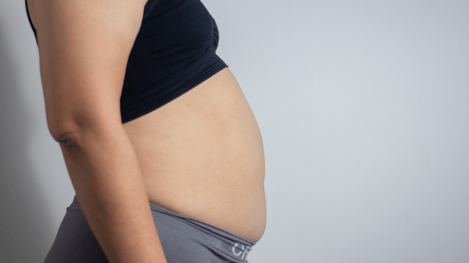 An image of a sideview bloated woman