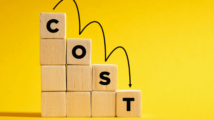 Wooden blocks arranged like a ladder spelling the word 'COST' downward on a yellow background.
